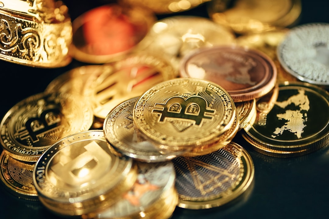 a pile of gold and silver coins sitting on top of a table