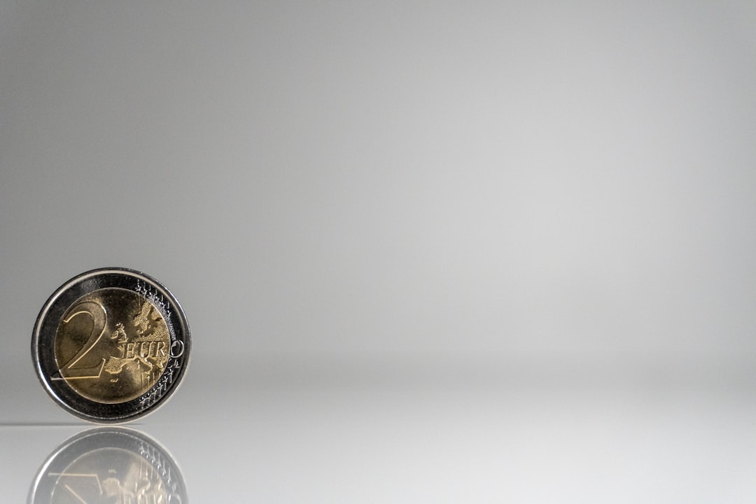 a close up of a coin on a reflective surface