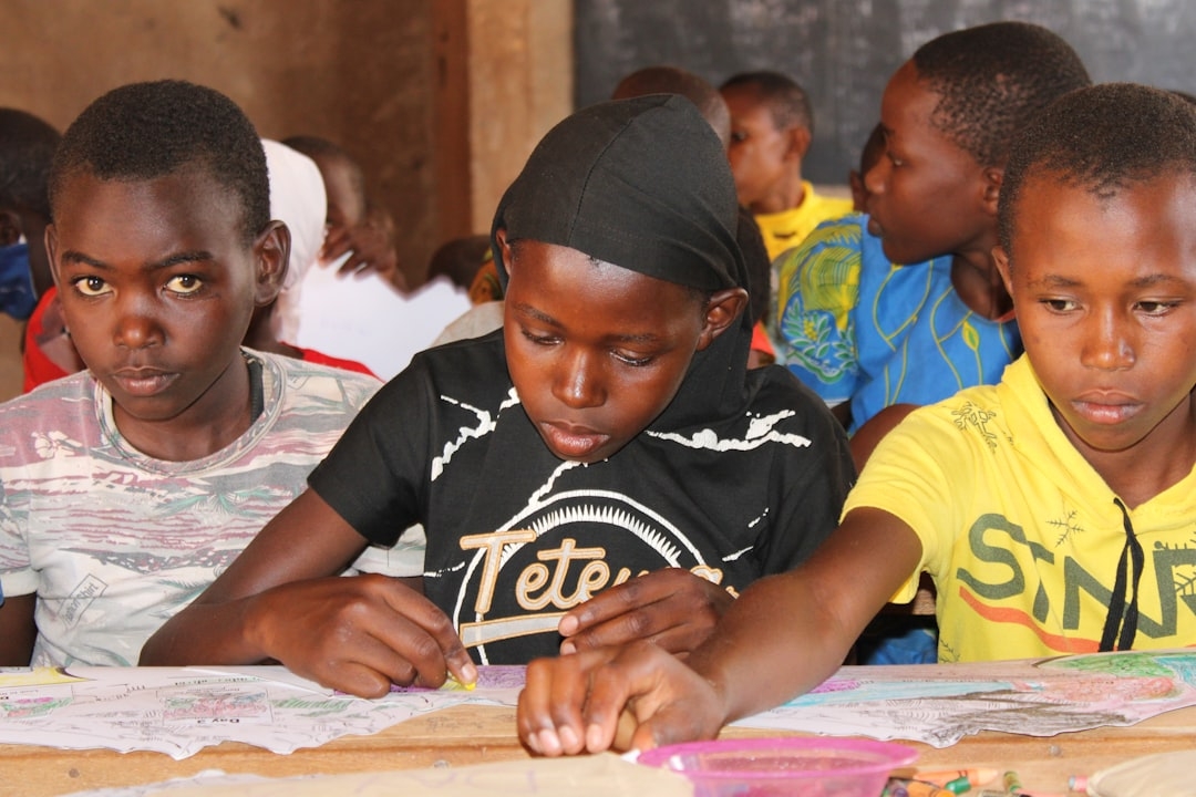 a group of young children sitting at a table