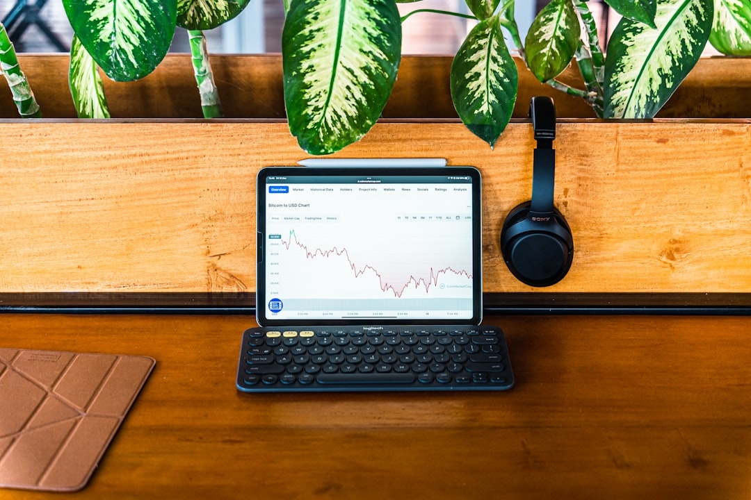 a laptop computer sitting on top of a wooden desk