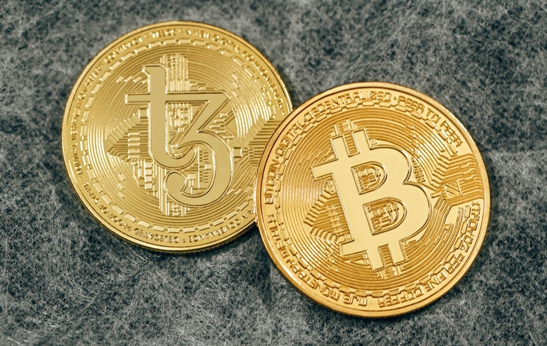 two gold bitcoins sitting side by side