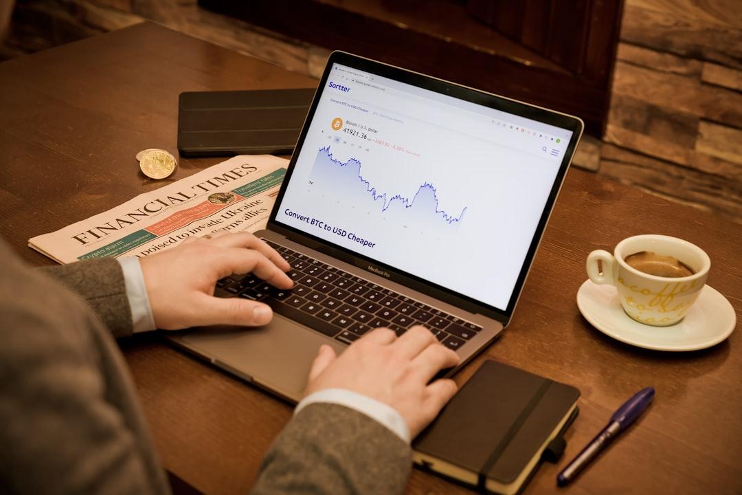 a person typing on a laptop on a table